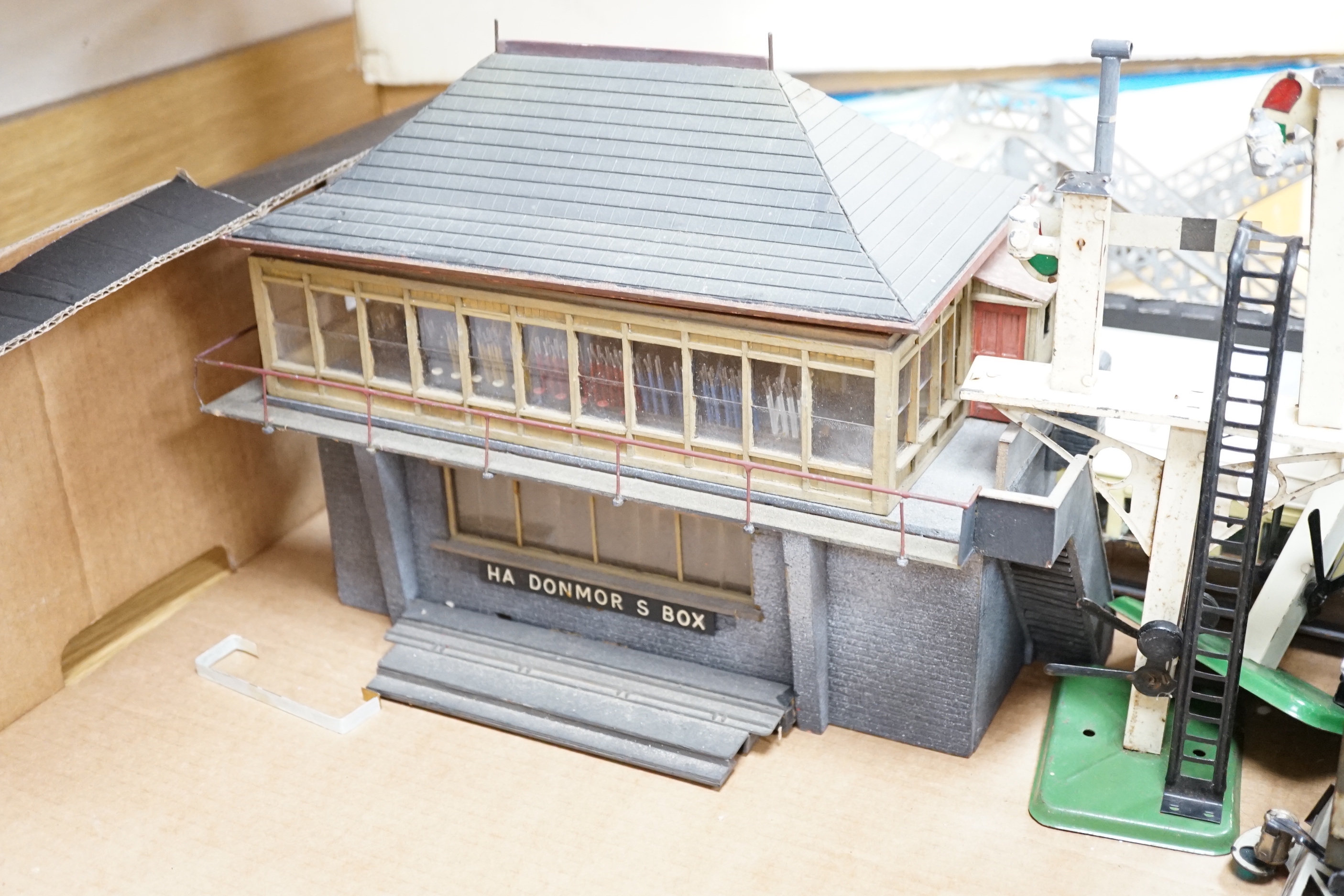 Eight items of Gauge One and 0 gauge model railway including; a Bassett-Lowke guard’s van, a cattle wagon, a gantry signal footbridge, and two further Hornby signals, a well detailed scratch built Signal Box, a scratch b